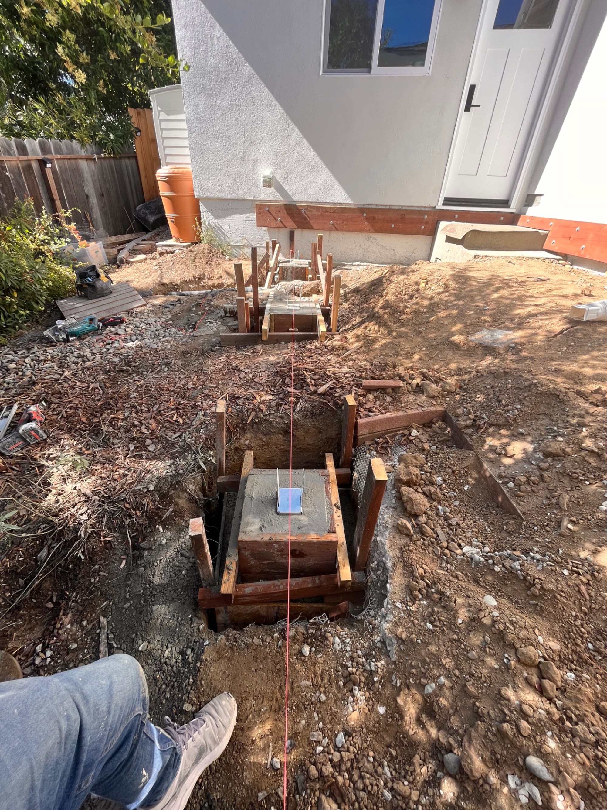 Poured footings and form boards in the backyard before the deck was framed