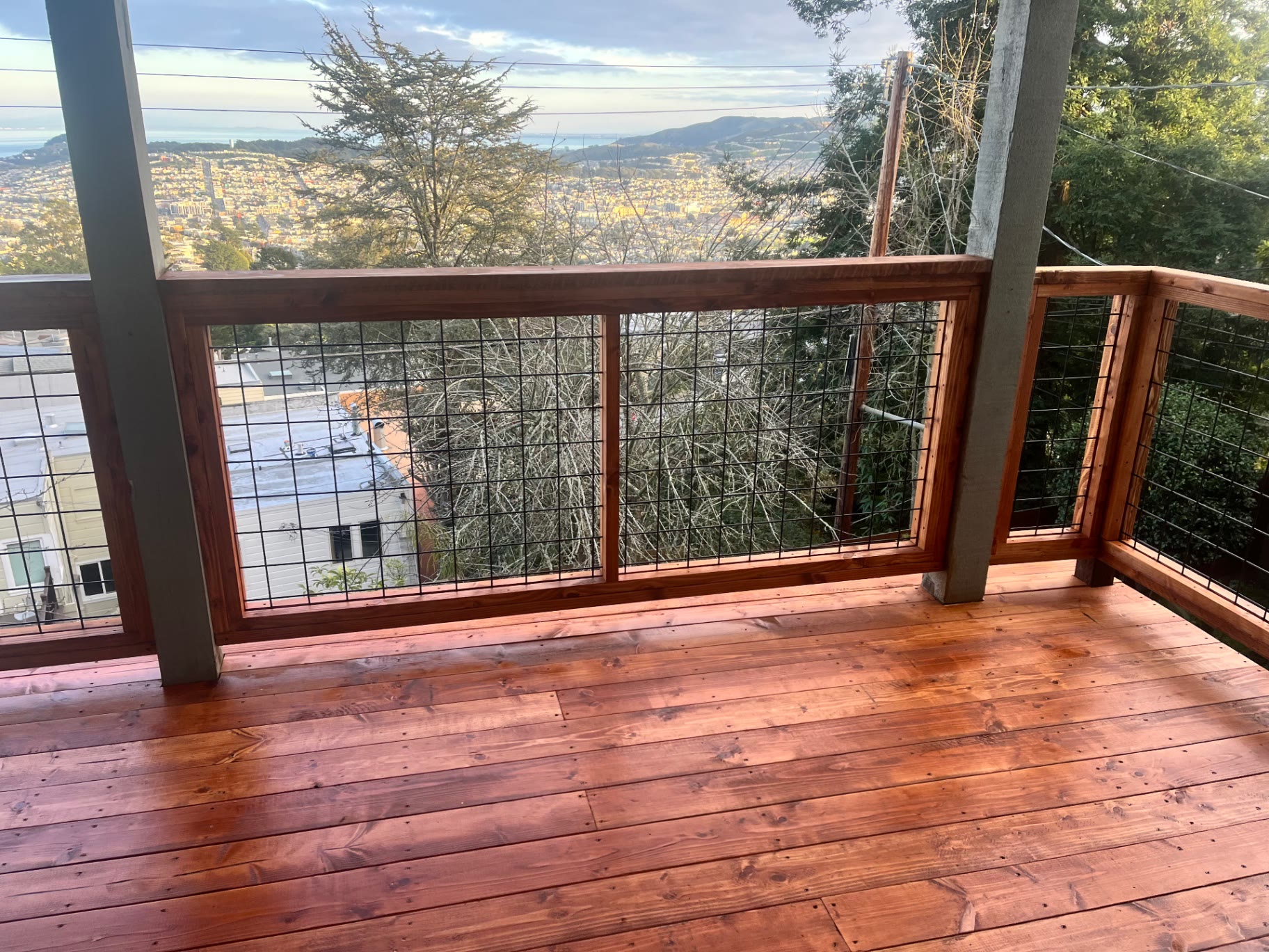 Deck railing framing a wide view of downtown San Francisco
