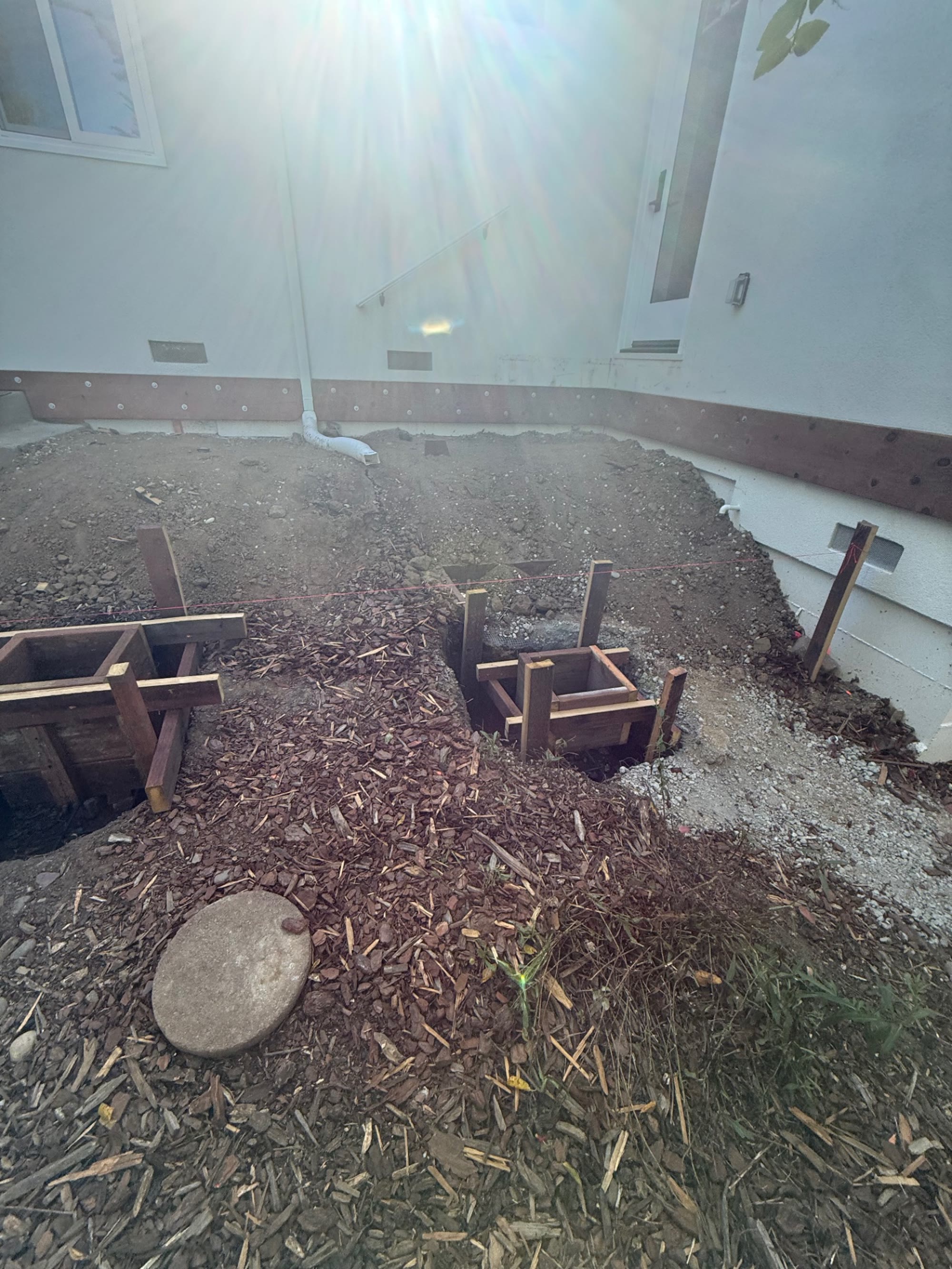 Graded dirt and ledger board along the foundation before framing started
