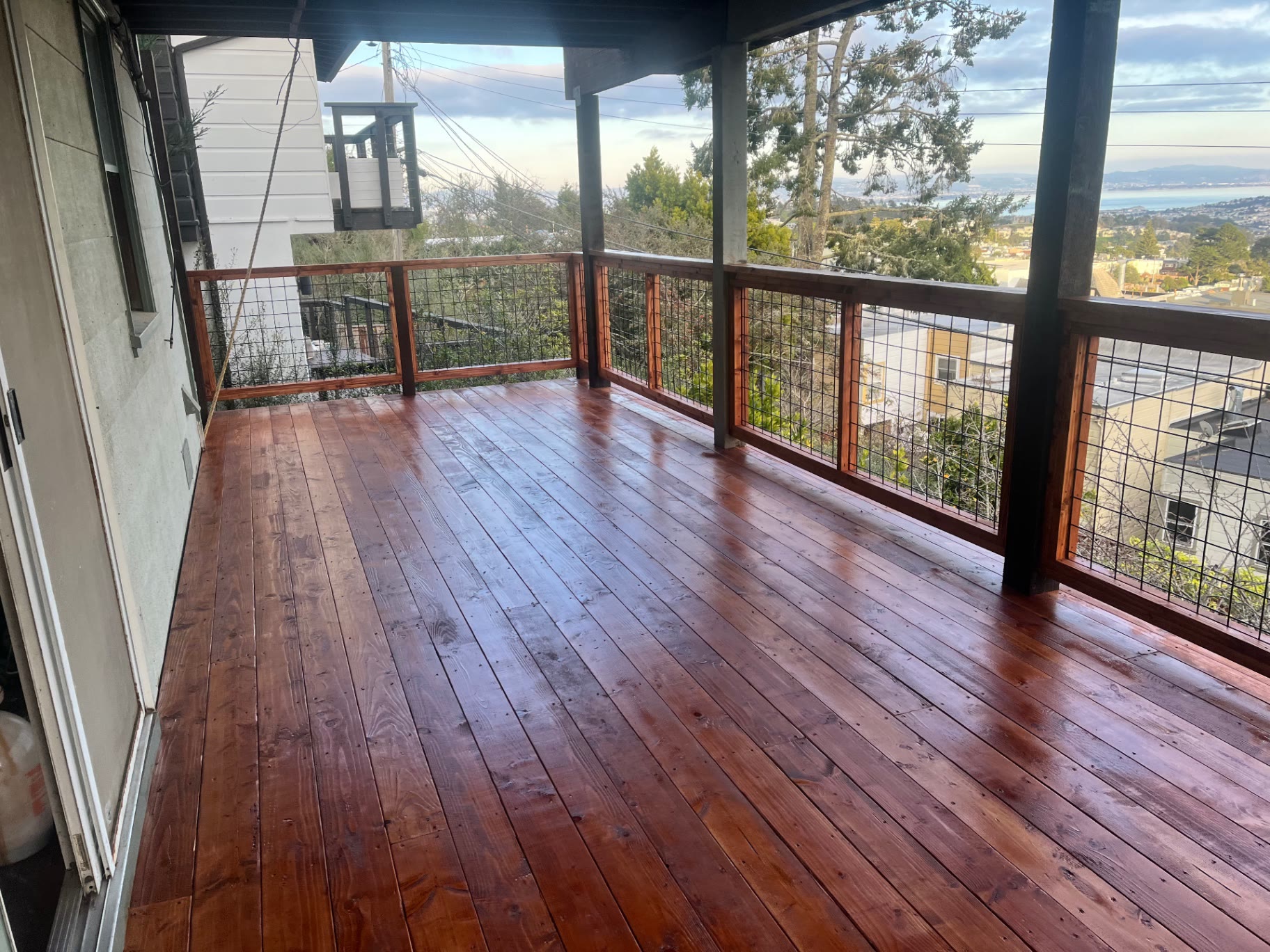 Covered section of the deck beside the house with bay views