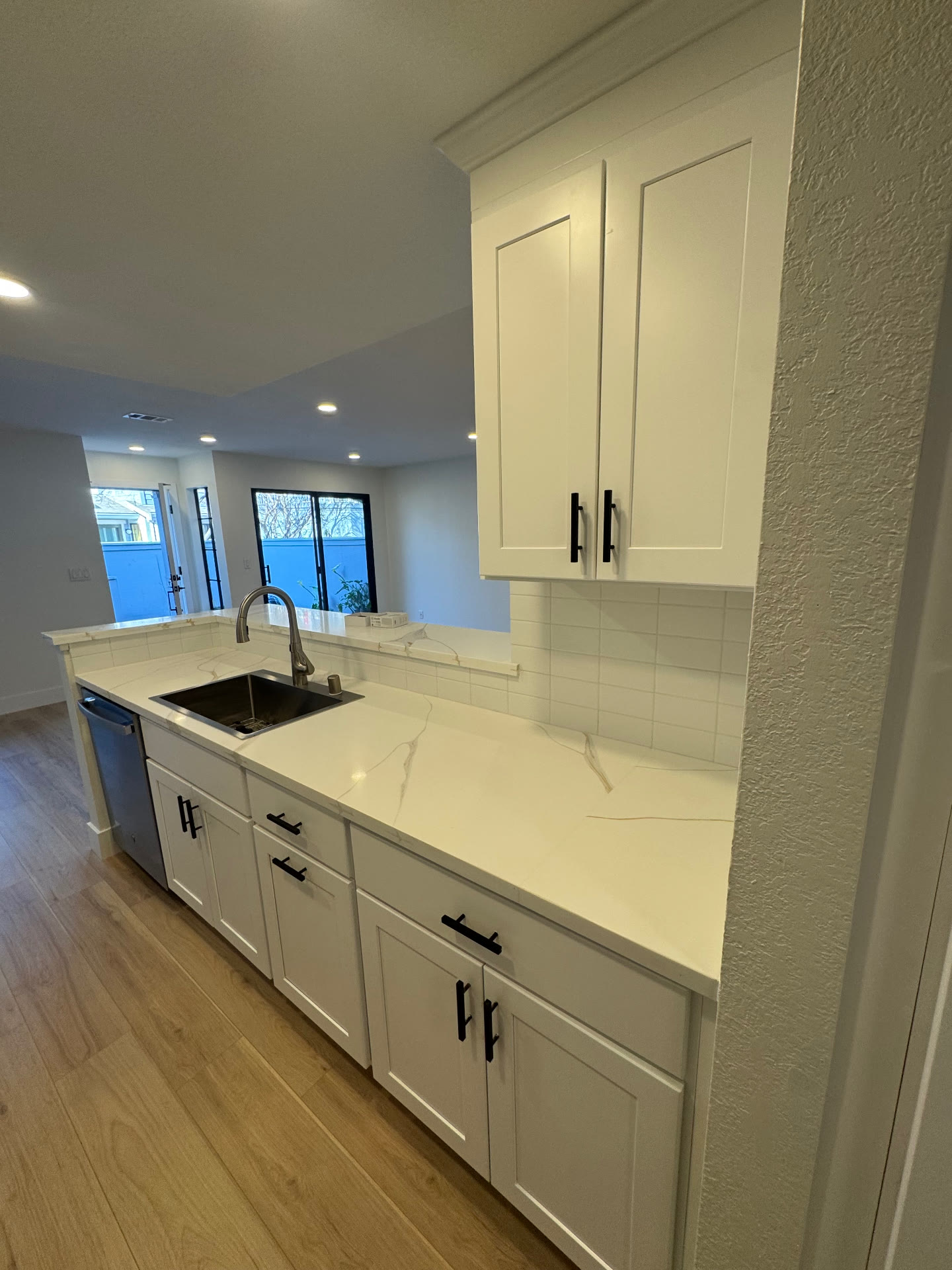 Sink run with quartz counter, undermount sink and pass through to the dining area
