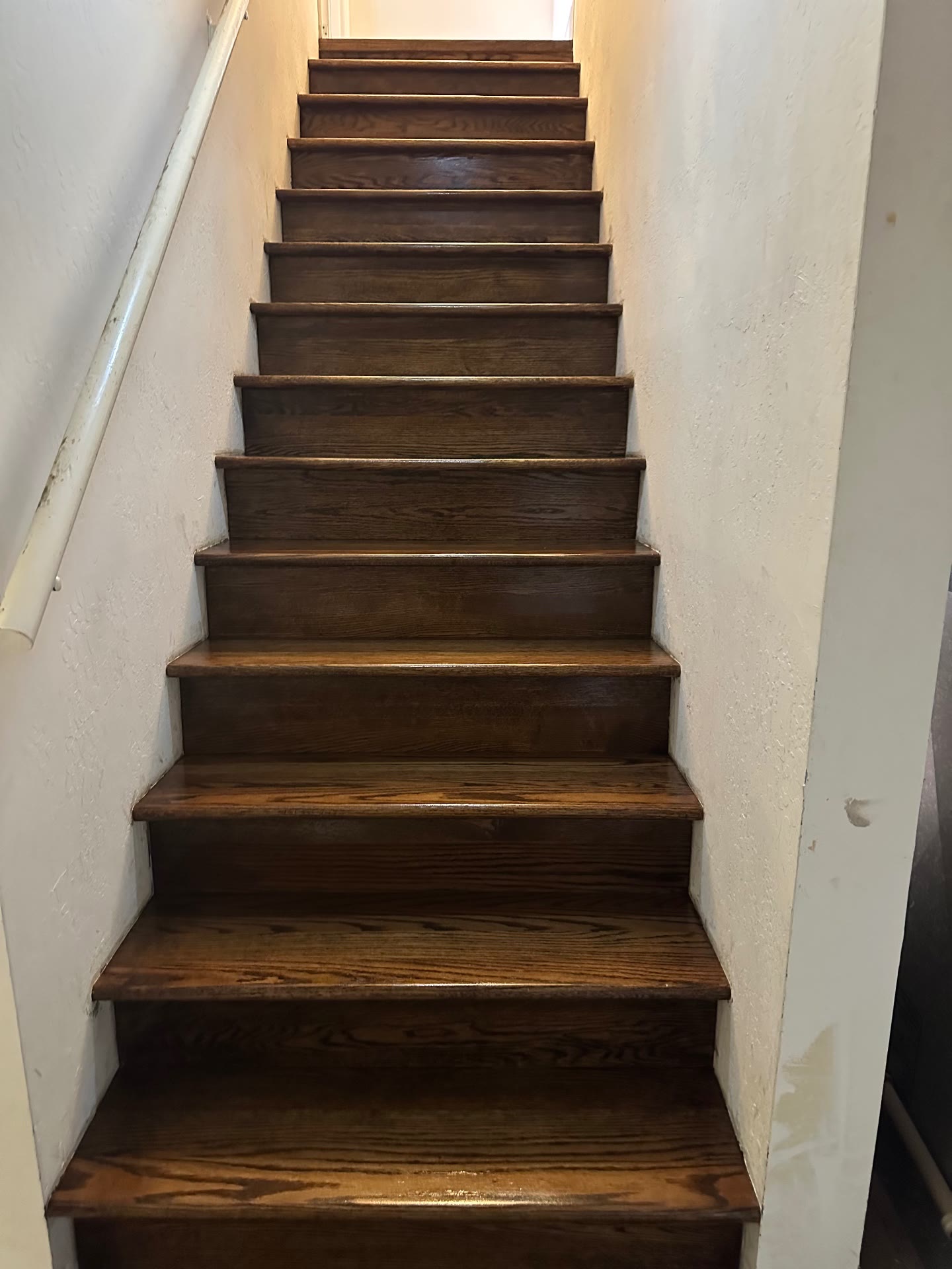 Staircase with oak treads and risers stained to match the floor