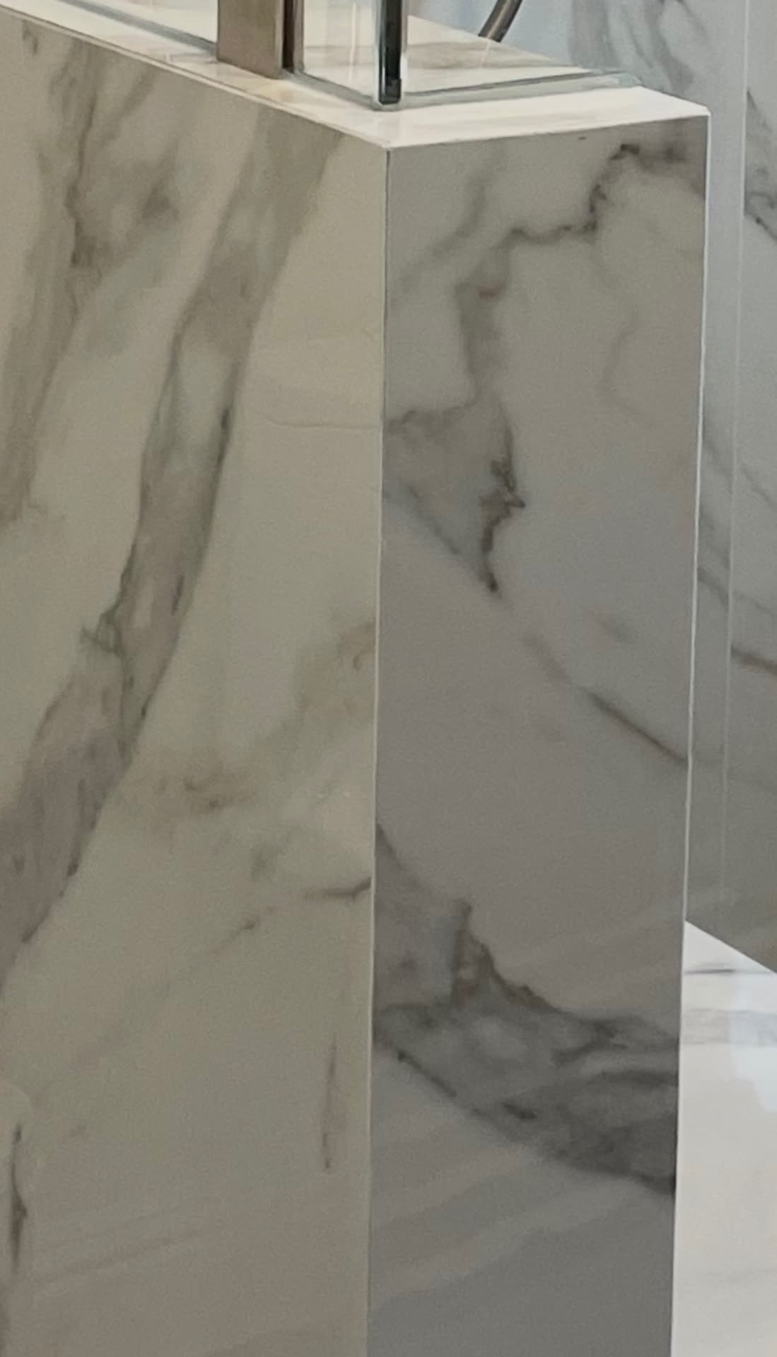 Mitered porcelain slab corner detail on the shower knee wall